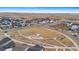 Wide aerial shot showcasing a residential area with a park and playground amid a developing neighborhood at 23820 E 34Th Ave, Aurora, CO 80019