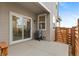 A spacious back patio area, perfect for outdoor entertaining with a sliding glass door and wood fence at 23820 E 34Th Ave, Aurora, CO 80019