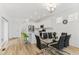 Bright dining room featuring modern glass table, seating for six, and open floor plan at 23820 E 34Th Ave, Aurora, CO 80019