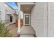 Inviting covered front porch with stylish stone and views of the friendly neighborhood at 23820 E 34Th Ave, Aurora, CO 80019