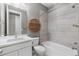 Bright bathroom with white cabinets, gray tile, and shower-tub combination at 11918 Mountview Ln, Broomfield, CO 80021