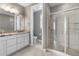 Modern bathroom featuring a granite countertop, double sink, and glass-enclosed shower at 11918 Mountview Ln, Broomfield, CO 80021