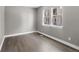 An empty bedroom featuring hardwood floors, light gray walls, and trim at 11918 Mountview Ln, Broomfield, CO 80021