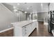 Open-concept kitchen with large island, stainless steel appliances, and modern lighting at 11918 Mountview Ln, Broomfield, CO 80021