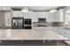 Gourmet kitchen featuring stainless steel appliances, white cabinets, and a stone countertop island at 11918 Mountview Ln, Broomfield, CO 80021
