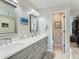 A modern bathroom features a double sink vanity, walk-in closet, and bright lighting at 8862 Chestnut Hill Ln, Highlands Ranch, CO 80130