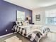 Stylish bedroom with a blue accent wall, plush carpet, and a window for natural light at 8862 Chestnut Hill Ln, Highlands Ranch, CO 80130