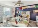 Bedroom with a ceiling fan, blue accent wall, and a white desk area near the window at 8862 Chestnut Hill Ln, Highlands Ranch, CO 80130