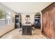 This home office features a large desk, wooden floors, black bookshelves, and a wooden closet at 8862 Chestnut Hill Ln, Highlands Ranch, CO 80130