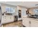 Modern kitchen showcasing white cabinets, stainless steel appliances, and a subway tile backsplash at 8862 Chestnut Hill Ln, Highlands Ranch, CO 80130