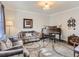 Comfortable living area with a piano, gray couches, crown molding, and a decorative rug at 8862 Chestnut Hill Ln, Highlands Ranch, CO 80130
