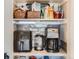 Organized pantry with shelves, featuring an air fryer, coffee maker, and other appliances at 8862 Chestnut Hill Ln, Highlands Ranch, CO 80130