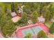 Aerial view showcasing the beautiful property with a tennis court, backyard fire pit and detached garage at 33208 Alta Vista Dr, Evergreen, CO 80439