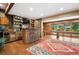 Basement area with wood paneling, a bar, pool table and a walkout to the backyard at 33208 Alta Vista Dr, Evergreen, CO 80439