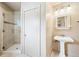 Bright bathroom with a glass-enclosed shower, sleek pedestal sink and ample space at 33208 Alta Vista Dr, Evergreen, CO 80439