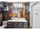 Rustic bathroom with wooden mirror frame, marble countertop and walk-in shower at 33208 Alta Vista Dr, Evergreen, CO 80439