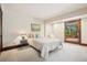 Bright bedroom with sliding glass doors to deck and neutral décor at 33208 Alta Vista Dr, Evergreen, CO 80439