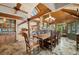 Open concept dining room with wood beamed ceiling, slate floors and views to living room and kitchen at 33208 Alta Vista Dr, Evergreen, CO 80439