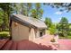 View of the home's back exterior featuring a tiled roof, skylights, sliding glass doors, and a wrap around deck at 33208 Alta Vista Dr, Evergreen, CO 80439