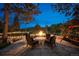 Stone patio features a fire pit with seating and string lights at 33208 Alta Vista Dr, Evergreen, CO 80439