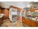 Bright kitchen featuring tile floors, wood cabinets, stainless steel appliances and open layout at 33208 Alta Vista Dr, Evergreen, CO 80439