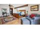 Cozy bedroom with a king bed, wood floors, a comfortable sitting area, and plenty of natural light at 33208 Alta Vista Dr, Evergreen, CO 80439