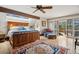 Cozy main bedroom showcasing a king bed, area rug, ceiling fan and access to a private deck at 33208 Alta Vista Dr, Evergreen, CO 80439