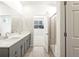 Bright bathroom featuring double vanity, frameless glass shower, and modern fixtures at 6050 Hourglass Dr, Brighton, CO 80601
