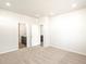 Well-lit bedroom with plush carpeting and an ensuite bathroom at 6050 Hourglass Dr, Brighton, CO 80601