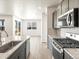 Modern kitchen with gas range and stainless steel appliances at 6050 Hourglass Dr, Brighton, CO 80601