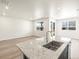 Kitchen island with granite countertop and stainless steel sink at 6050 Hourglass Dr, Brighton, CO 80601
