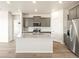 Modern kitchen with a large island, granite countertops, stainless steel appliances, and abundant cabinet space at 6050 Hourglass Dr, Brighton, CO 80601