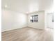 Bright and spacious living room with wood flooring, recessed lighting, large window, and ample space for gatherings at 6050 Hourglass Dr, Brighton, CO 80601