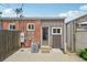 A concrete patio featuring a small door entrance and a small AC unit outside at 3444 Lawrence St, Denver, CO 80205
