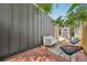 A backyard featuring a red tile patio with outdoor seating beneath a shaded canopy at 3444 Lawrence St, Denver, CO 80205