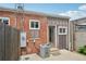 A concrete patio featuring a small door entrance and a small AC unit outside at 3444 Lawrence St, Denver, CO 80205