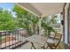 Inviting front porch with a table, chairs, and wrought iron railing, ideal for outdoor seating and relaxation at 3444 Lawrence St, Denver, CO 80205