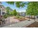 Well-manicured front yard with a brick walkway, landscaping, and mature trees in a residential neighborhood at 3444 Lawrence St, Denver, CO 80205