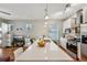 Open kitchen and living area with a large quartz island and stainless steel appliances at 3444 Lawrence St, Denver, CO 80205