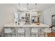 Bright kitchen features stainless appliances, white cabinets, and large center island with bar seating at 3444 Lawrence St, Denver, CO 80205