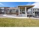 Exterior view of a home with a manicured lawn and covered back porch at 8230 S White Crow St, Aurora, CO 80016