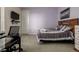 Bedroom featuring a bed, tv, desk and chair, and wall art at 8230 S White Crow St, Aurora, CO 80016
