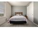 Bright bedroom featuring neutral tones, a plush bed, a closet and a bright window with neighborhood views at 8230 S White Crow St, Aurora, CO 80016