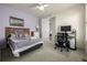 Comfortable bedroom featuring a ceiling fan, neutral carpet, and large picture window for plenty of natural light at 8230 S White Crow St, Aurora, CO 80016
