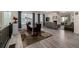 Open concept dining and living space features wood floors and view to living area at 8230 S White Crow St, Aurora, CO 80016