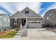 Inviting home with two-car garage, manicured lawn, stone and siding details and concrete stairs to front entry at 8230 S White Crow St, Aurora, CO 80016
