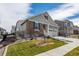 Inviting home with two-car garage, manicured lawn, stone and siding details and concrete stairs to front entry at 8230 S White Crow St, Aurora, CO 80016
