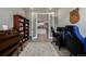 Spacious home office with piano, view of the kitchen through french doors, and luxury plank flooring at 8230 S White Crow St, Aurora, CO 80016