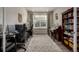 A bright and airy home office space with great natural light, desk, musical intruments and hardwood floors at 8230 S White Crow St, Aurora, CO 80016