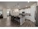 Modern kitchen features white cabinets, pendant lighting, and island with seating at 8230 S White Crow St, Aurora, CO 80016